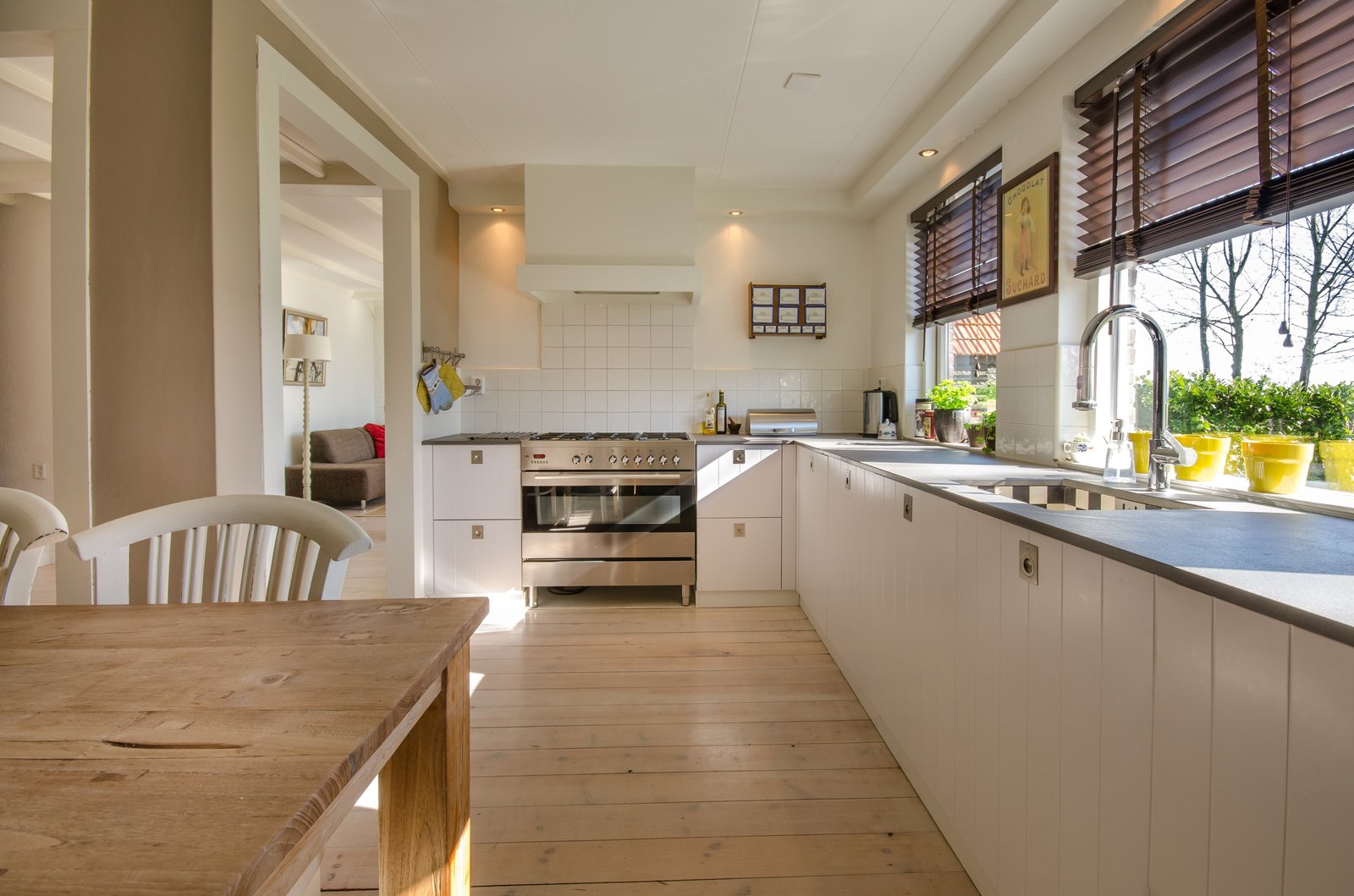 Family kitchen with chrome mixer at the window sink after renovation plumbing