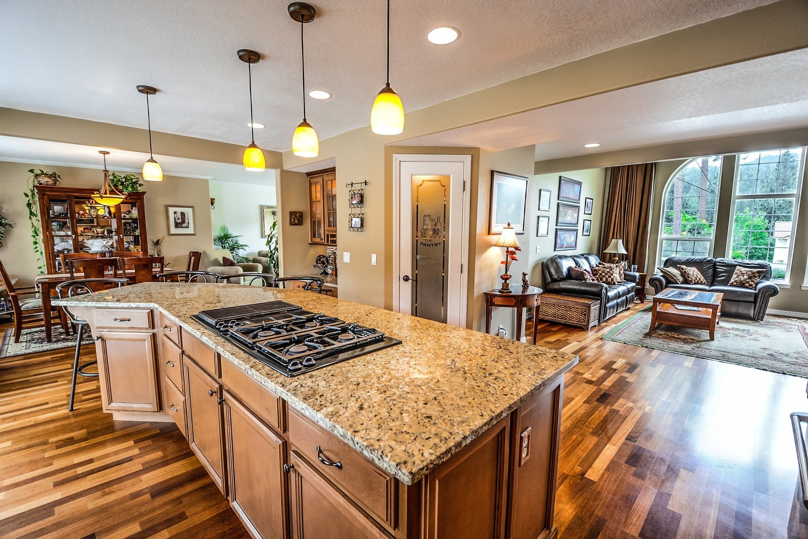 Open-plan kitchen with granite island after renovation plumbing
