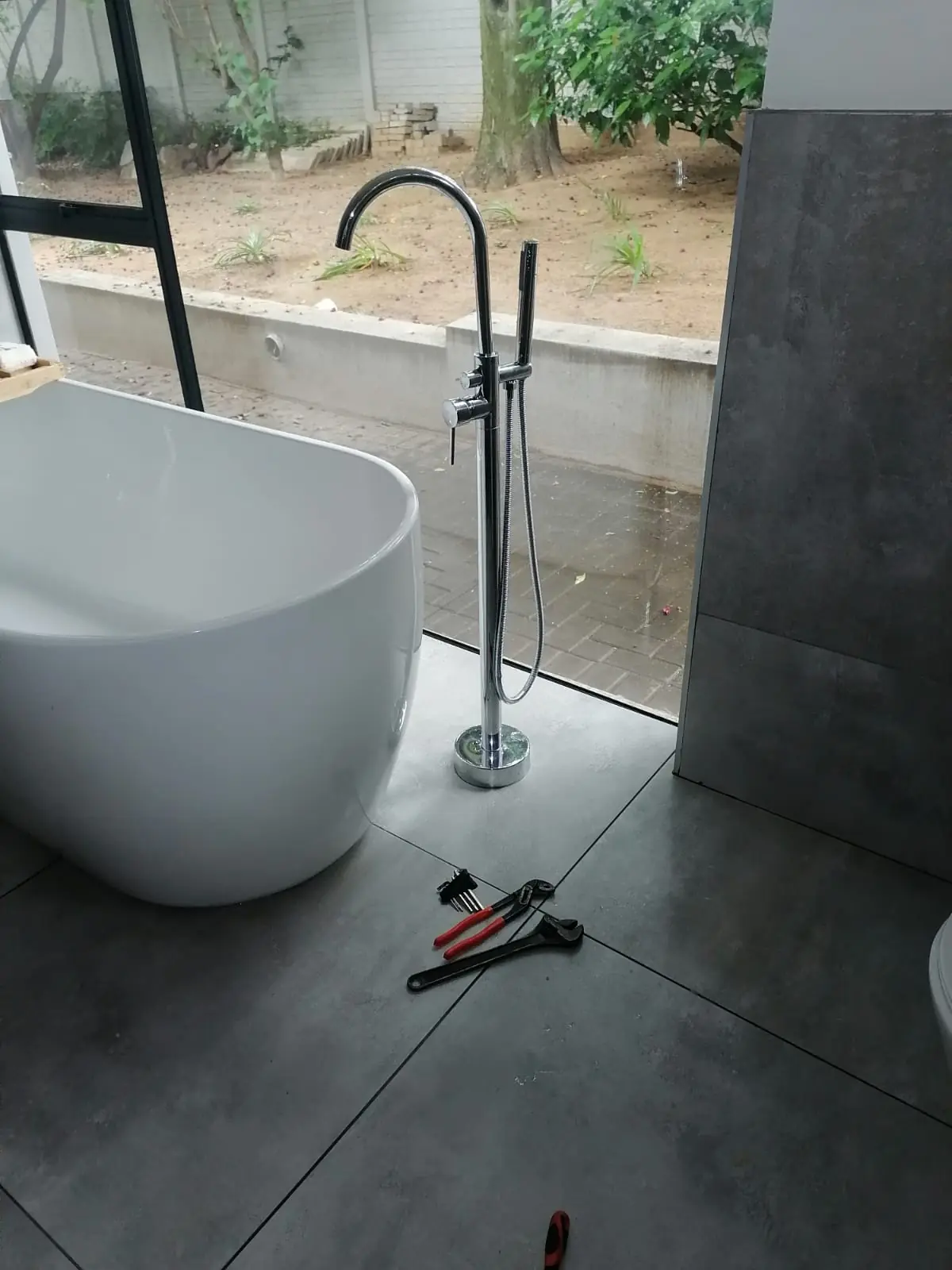 Concealed plumbing and waste pipe installation before tiling in a renovated bathroom