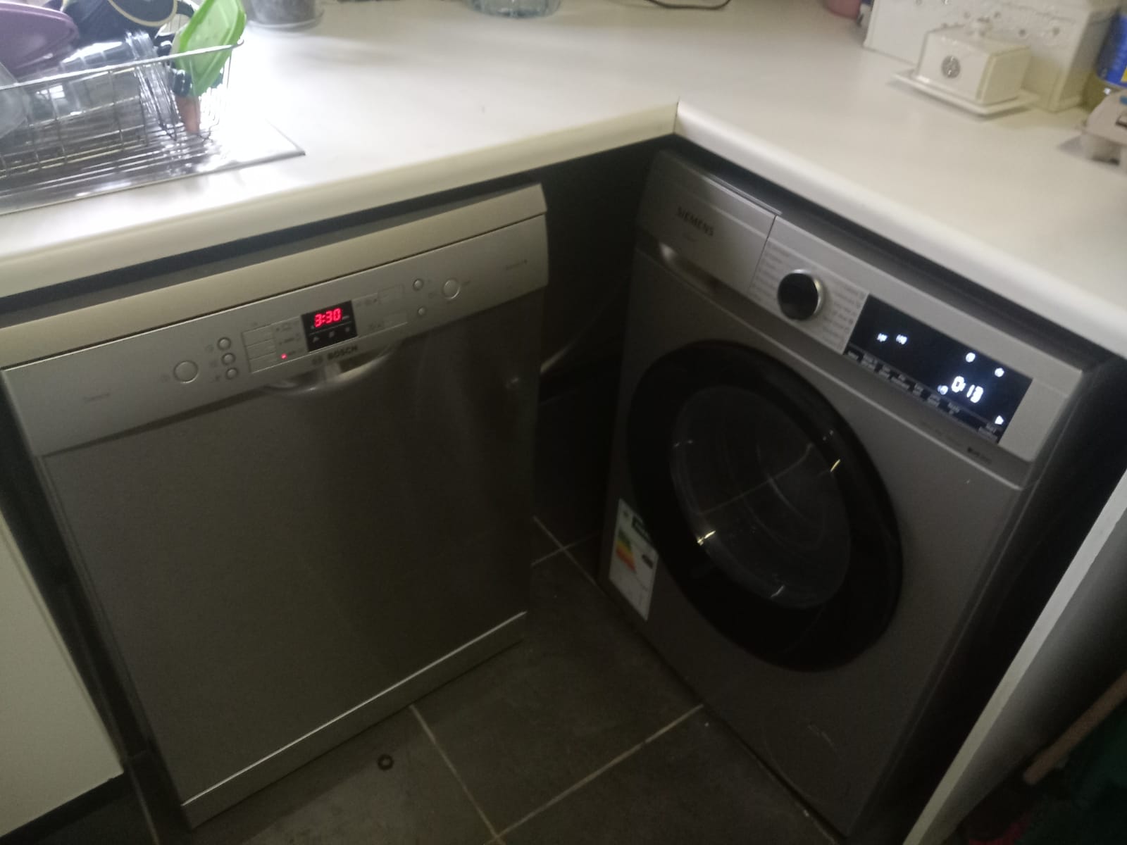 Dishwasher rear service area showing hose routing