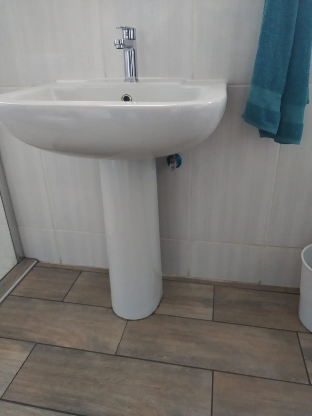 Bathroom basin with waste outlet checked during blocked basin cleaning