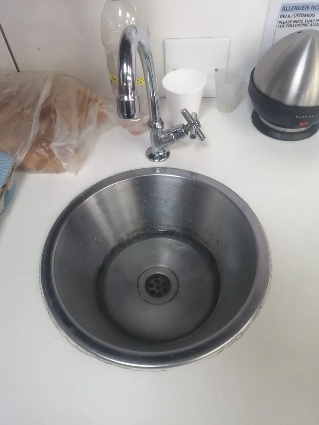 Kitchen sink with standing water during blocked sink cleaning
