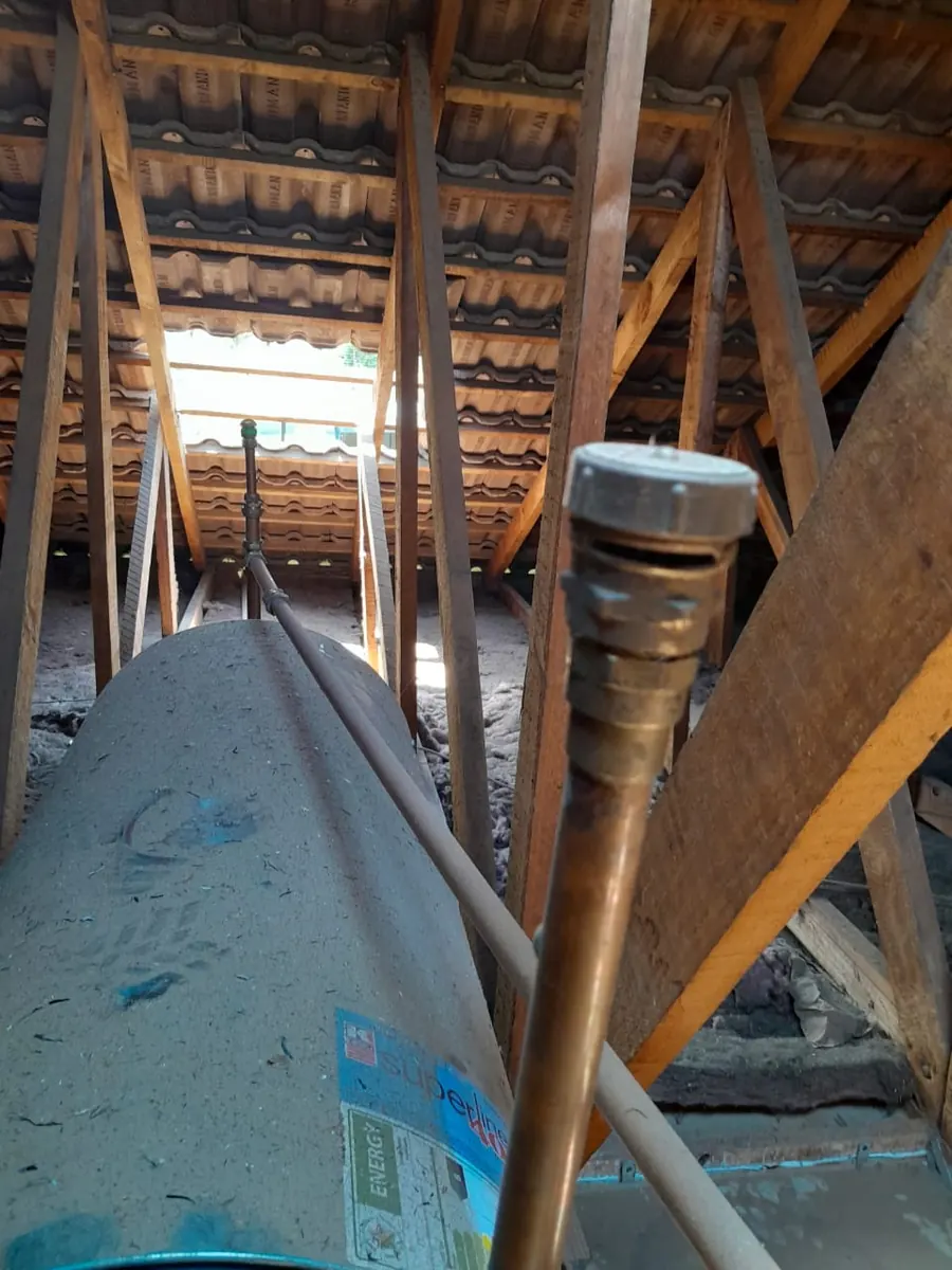 Old geyser in roof space prepared for controlled draining and safe removal