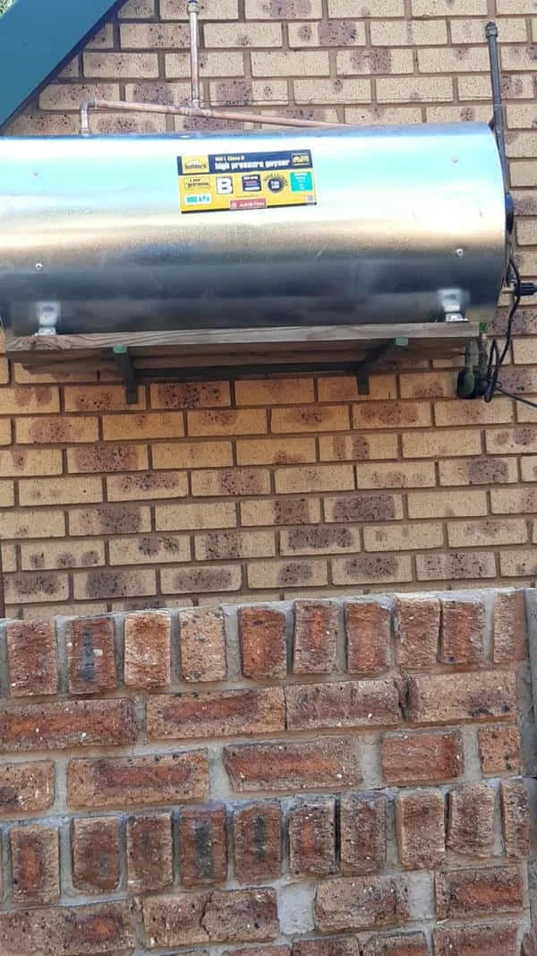 External wall-mounted geyser replacement completed with pipework and brackets
