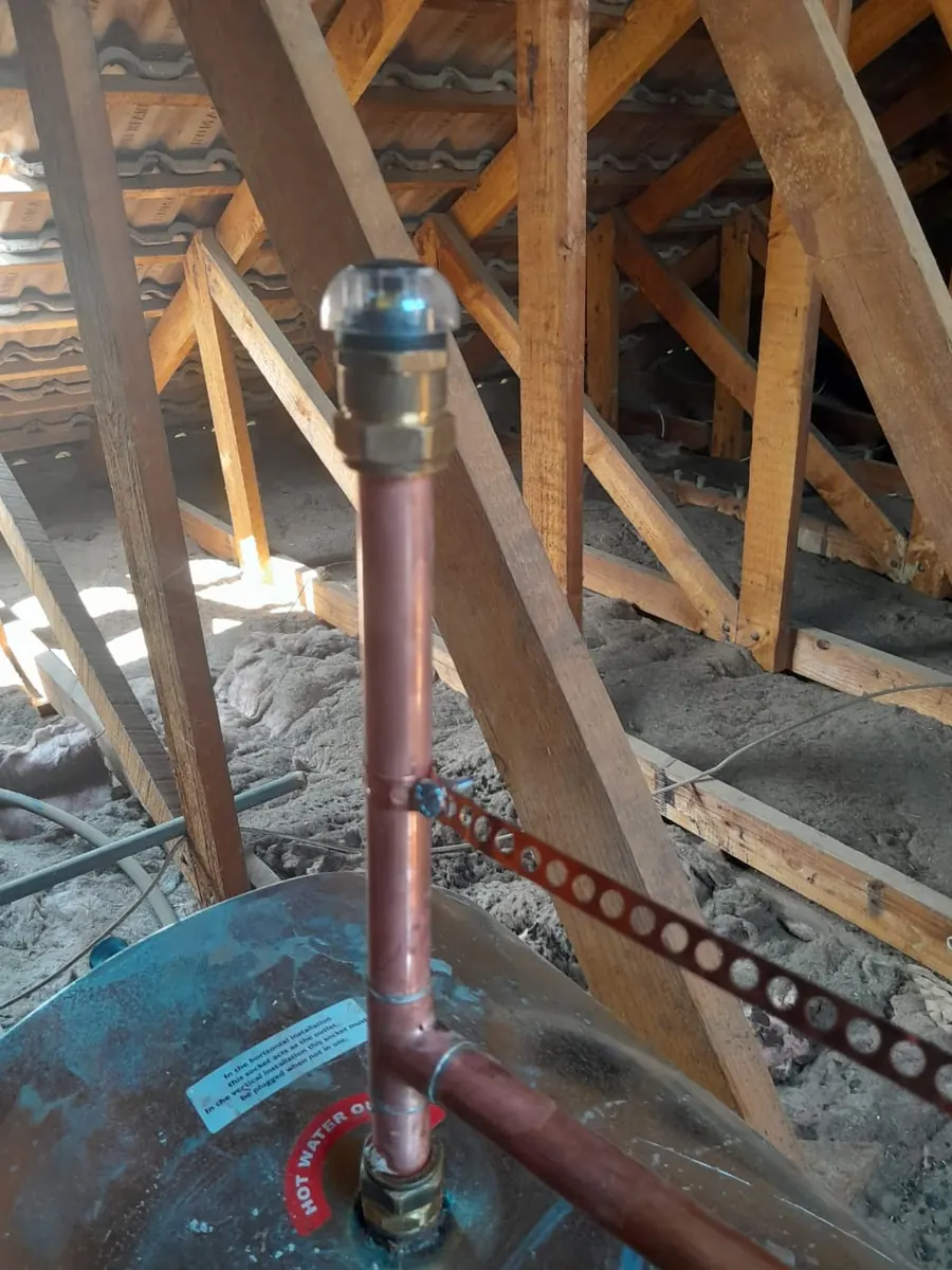 Copper pipework and vacuum breaker inspected on a geyser before replacement decision