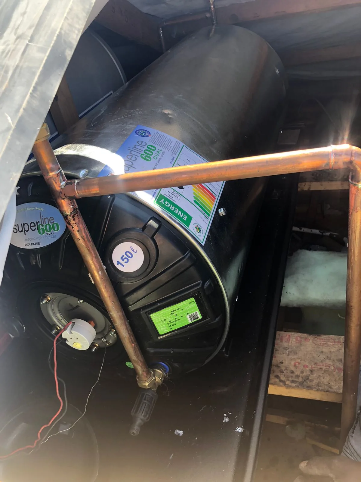 New geyser connected in a roof space with copper pipework and safety fittings
