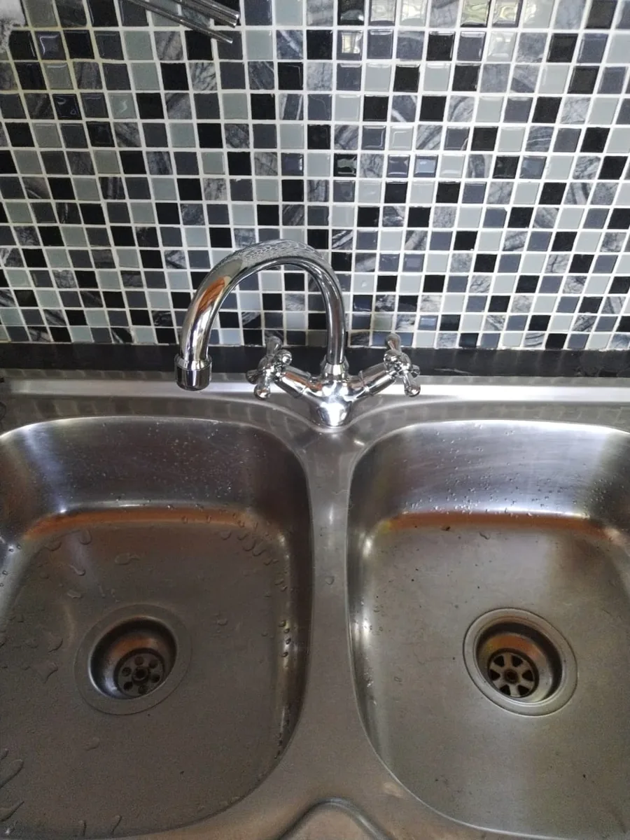 Kitchen sink checked after slow drainage and waste restriction