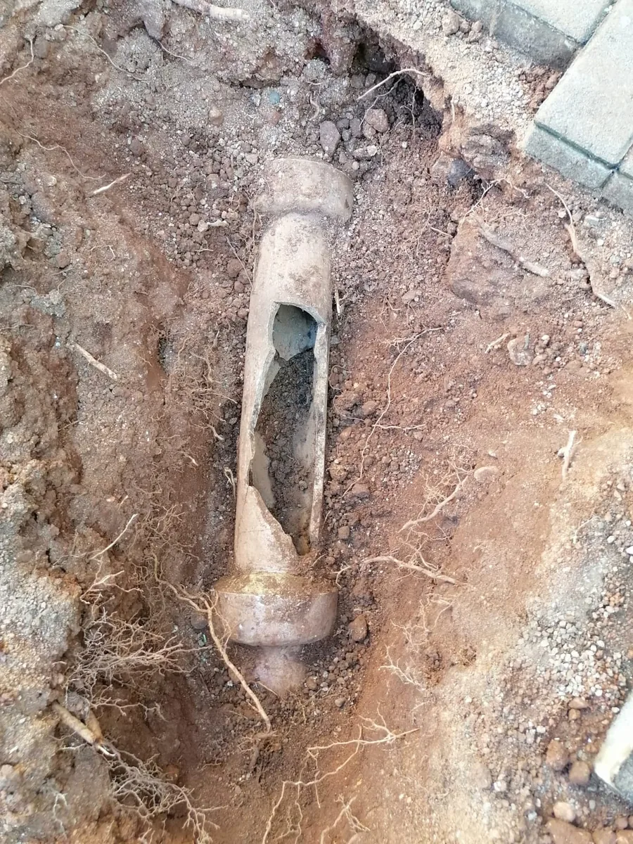 Broken underground drain pipe exposed during recurring blockage investigation