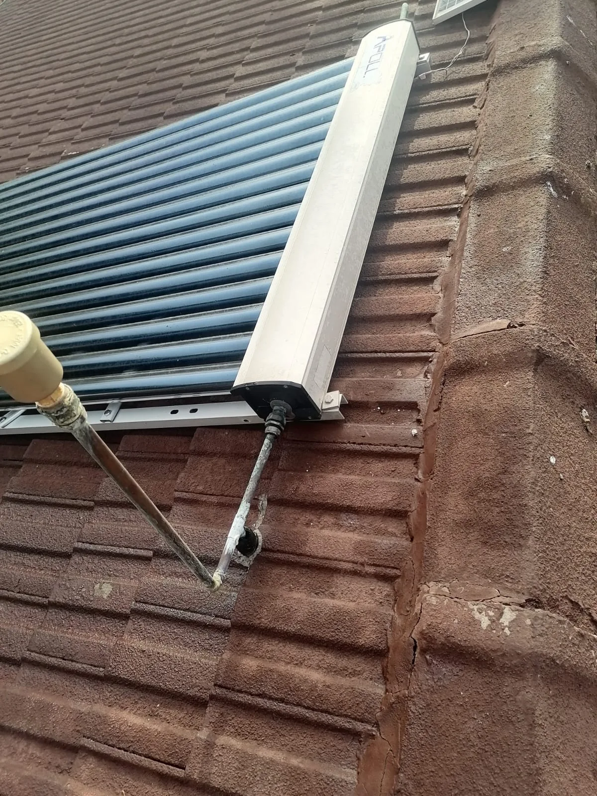 evacuated tube solar geyser system and controller components on roof