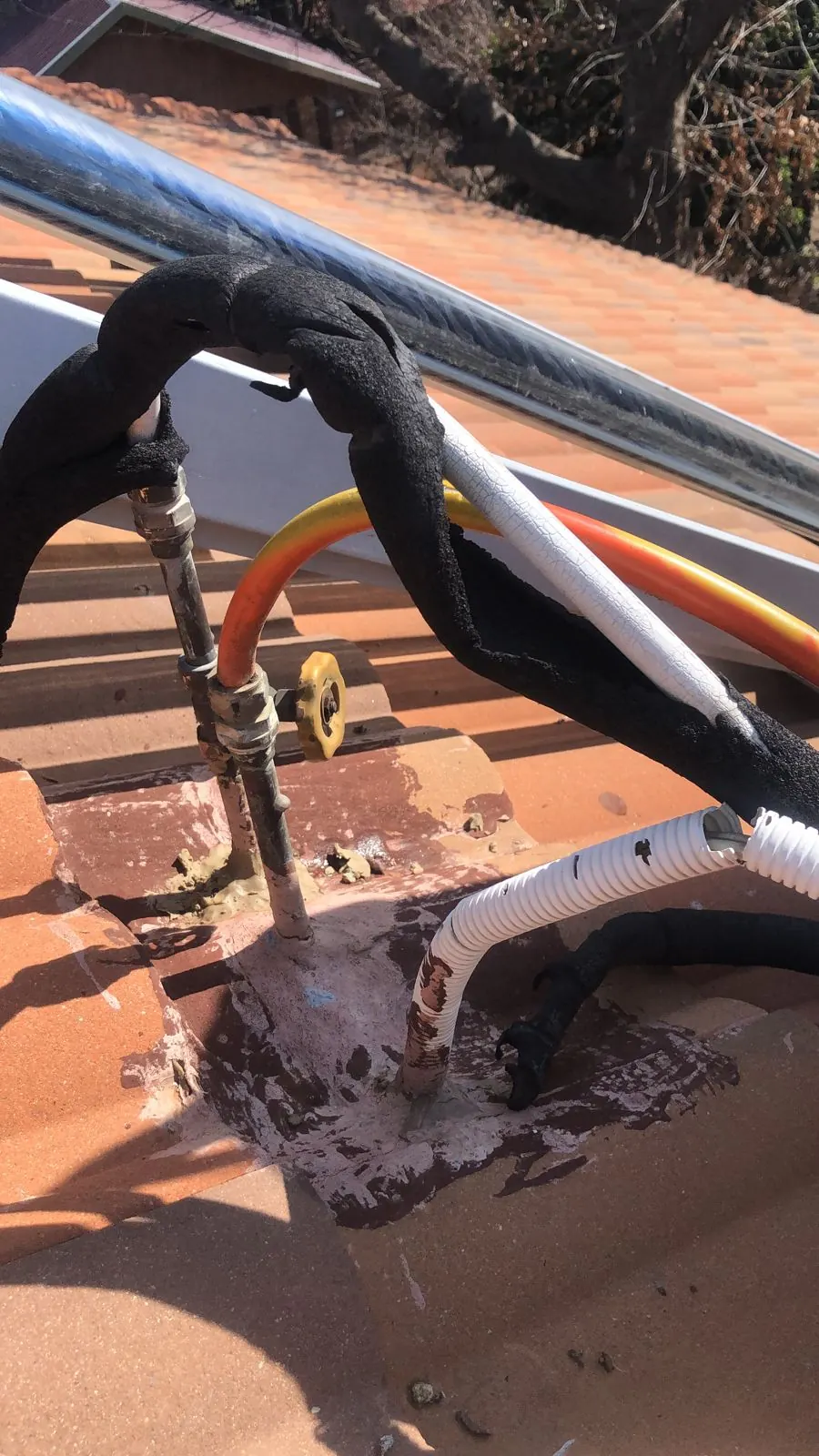Solar geyser pipe section removed during repair on a metal roof