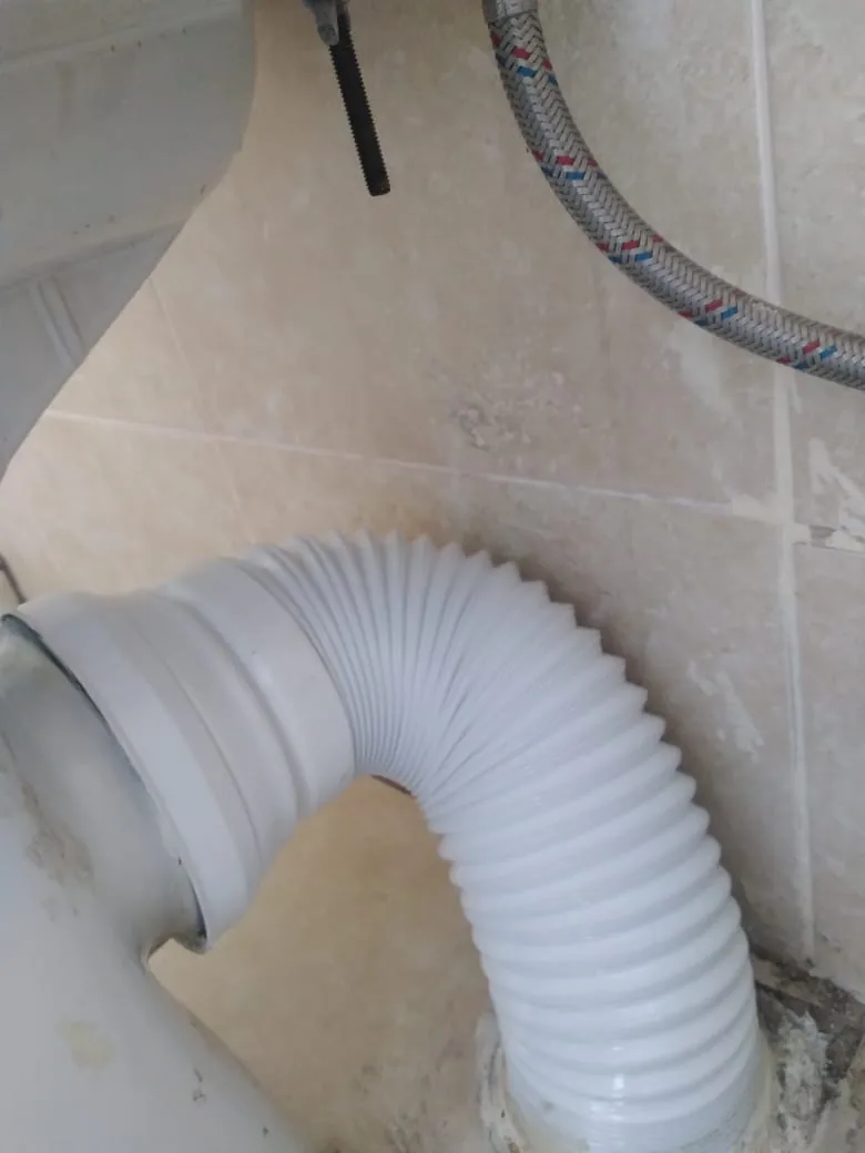 Toilet pan connector and waste pipe repair behind a toilet