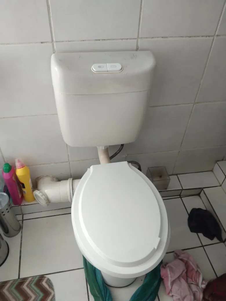Toilet and cistern with pipework showing when replacement may be better than repair