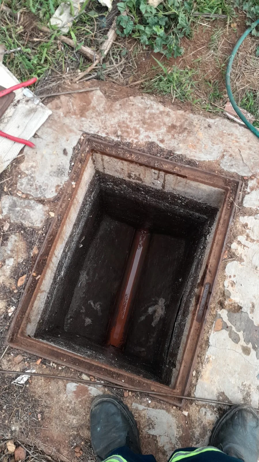 Open drain access point showing main drain and sewer line inspection