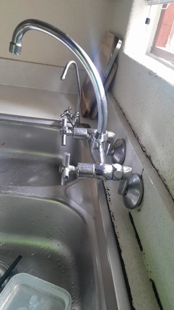 Wall-mounted kitchen mixer repair by a Zanberg plumber