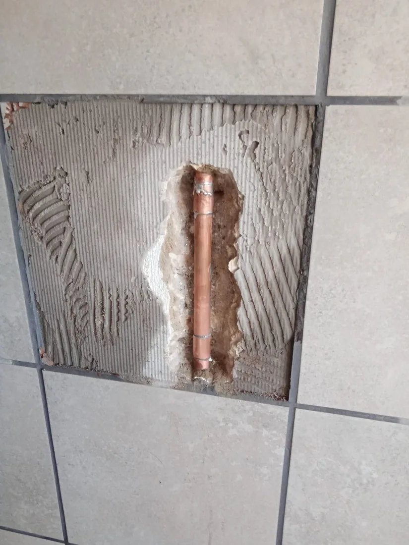 Hidden copper pipe leak behind tiles exposed and repaired by a Zandvlei plumber