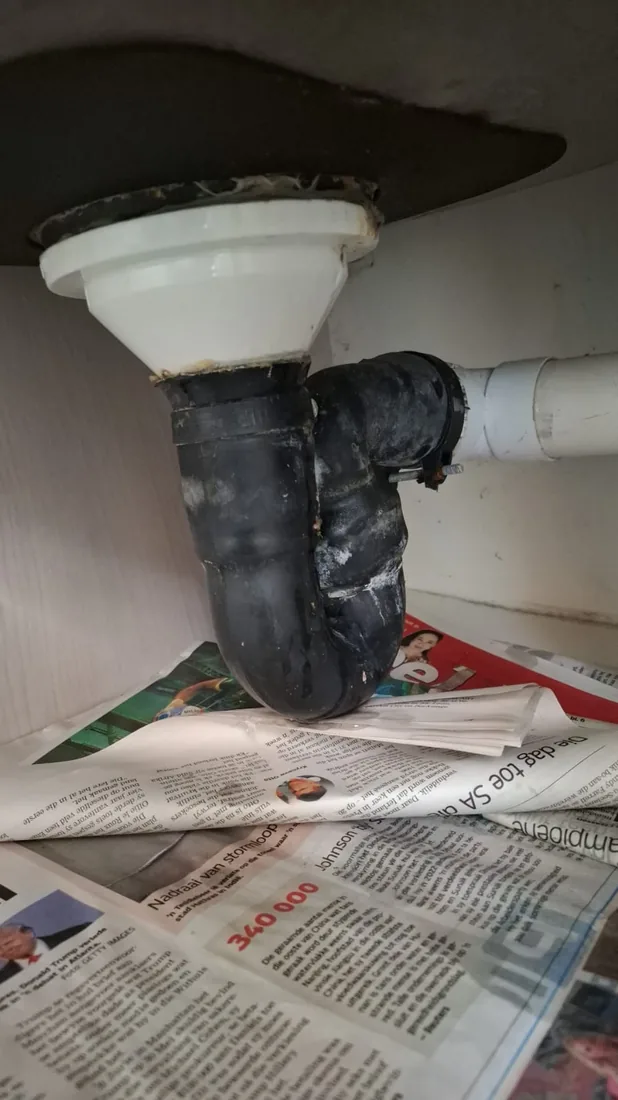 Leaking black basin waste trap and under-sink pipe repair in Zeekoevlei