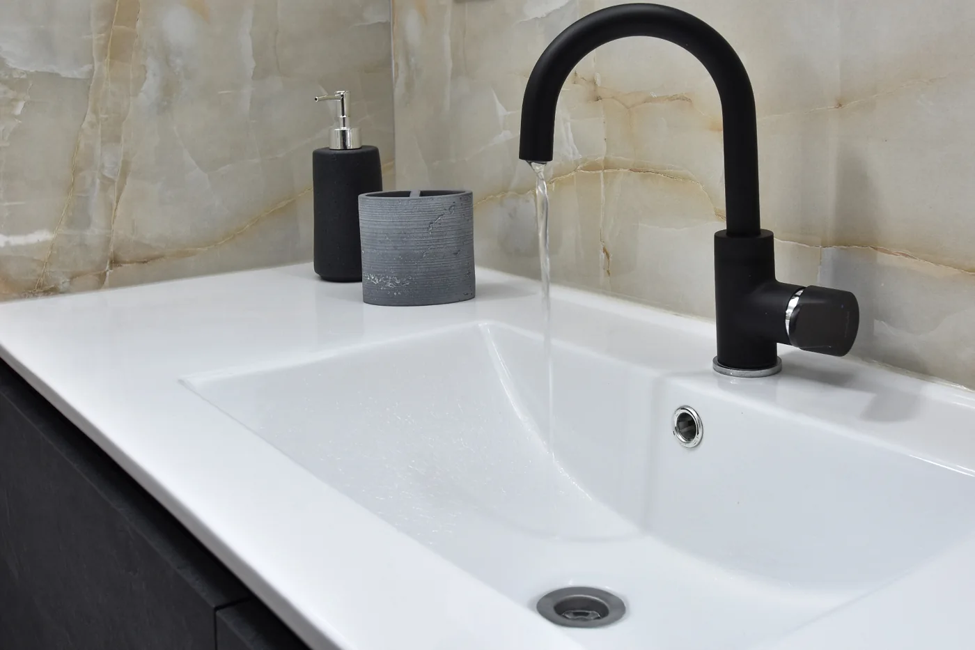 Bathroom renovation contractors planning a white basin and black mixer installation