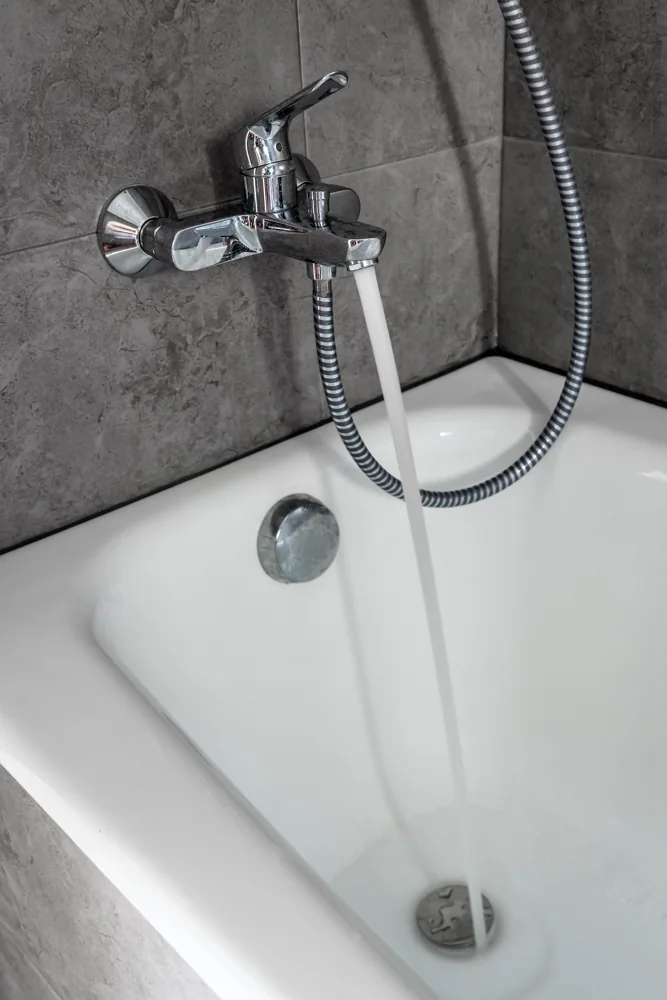Bathroom renovation quotation detail showing a chrome bath mixer and shower handset