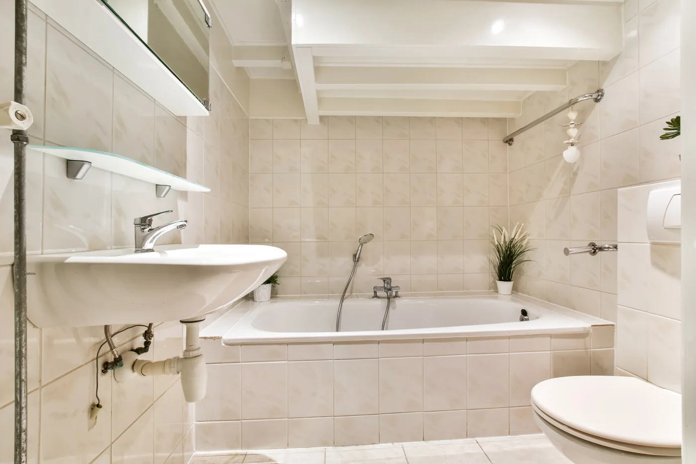 Bathroom renovations Gauteng design inspiration with a tiled bath, basin and toilet