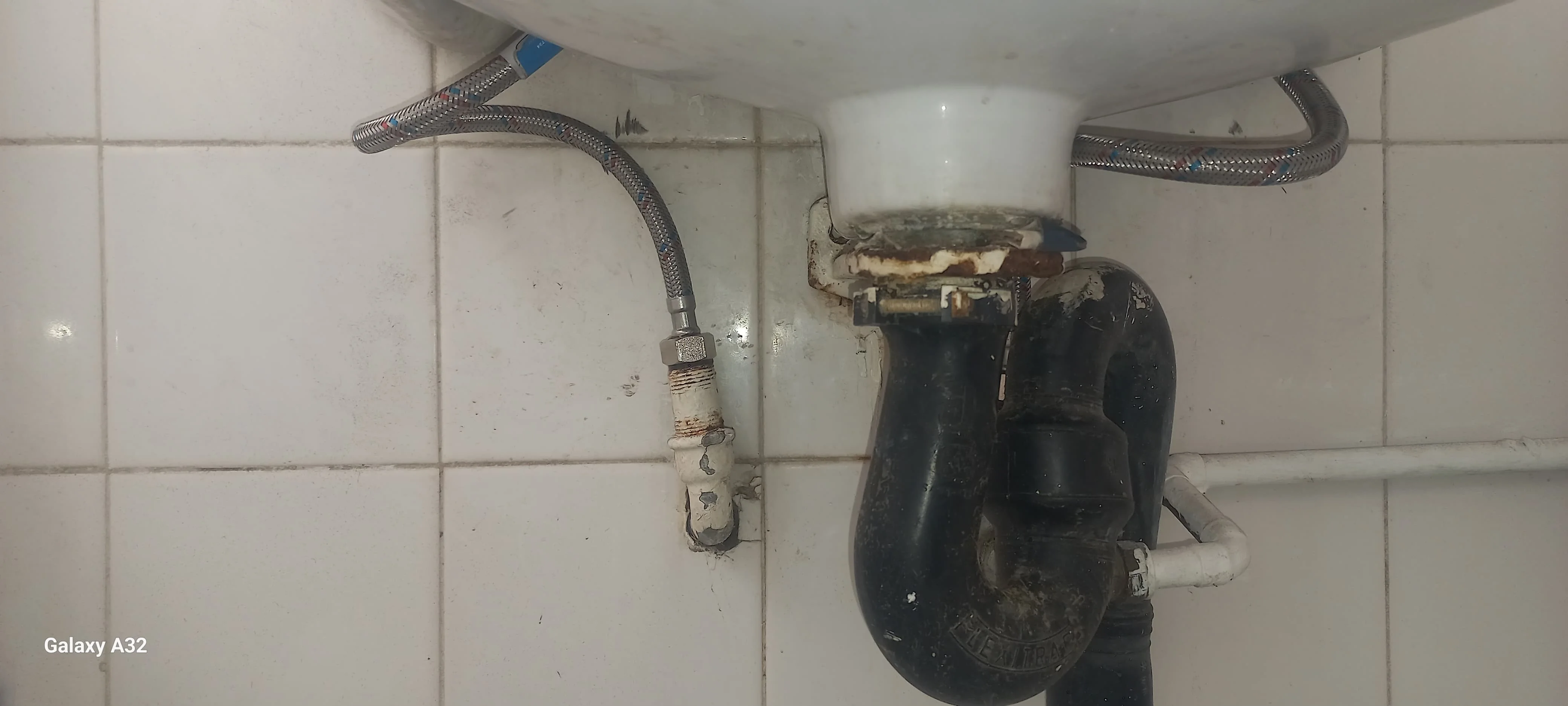 Close-up of leaking outside angle valve with water droplets on the fitting