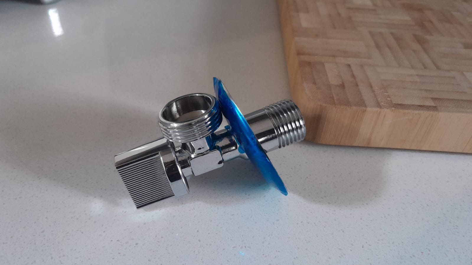 New chrome angle valve for toilet replacement in Randburg, showing shut-off valve with threaded connections ready for installation to control water supply and prevent toilet leaks.