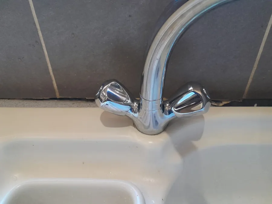 Basin Mixer Repair Chrome basin mixer fitted on a bathroom basin after repair or replacement