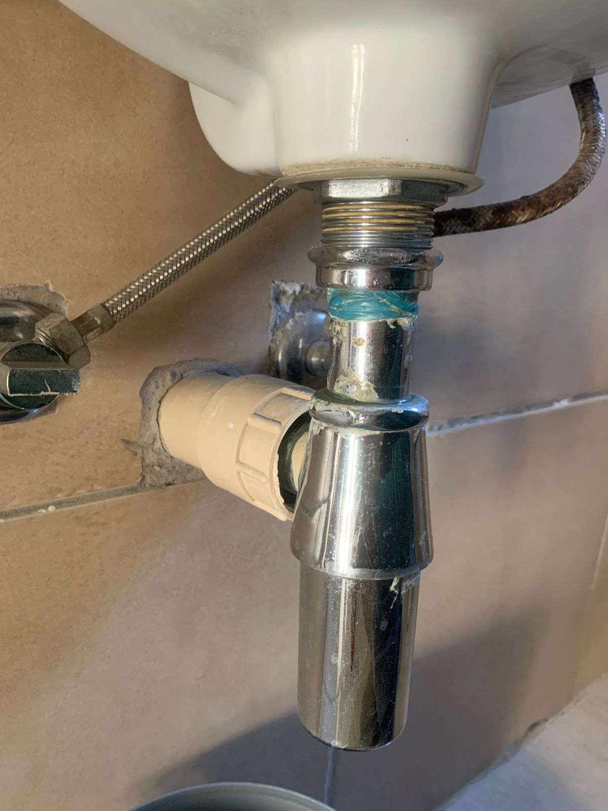 Blocked bottle trap cleared in Randburg, showing under-basin chrome bottle trap and sink waste pipe after removing blockage and restoring proper drainage and water flow.