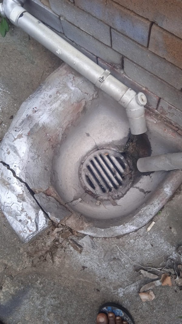 Fully blocked gulley filled with water and dirt