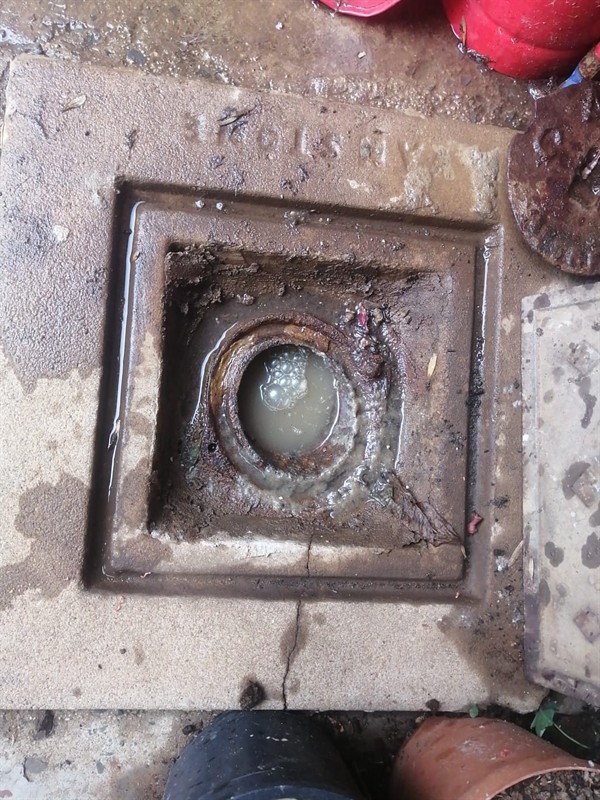 Drain pipe with standing water due to heavy blockage in Apex Industrial