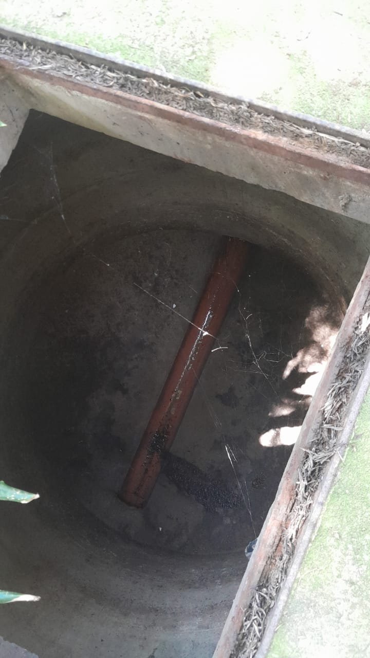 Blocked drain inspection chamber with partially blocked underground sewer pipe in Linden