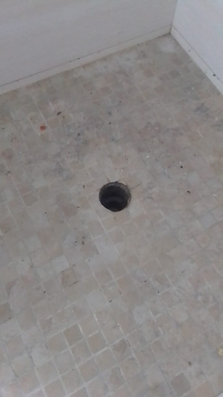 Shower floor drain in Kempton Park after blocked shower cleared, showing open drain outlet and clean tiled shower base following drainage maintenance.