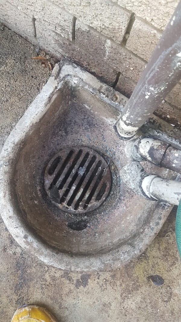 Drain cleaning job in progress with tools in use