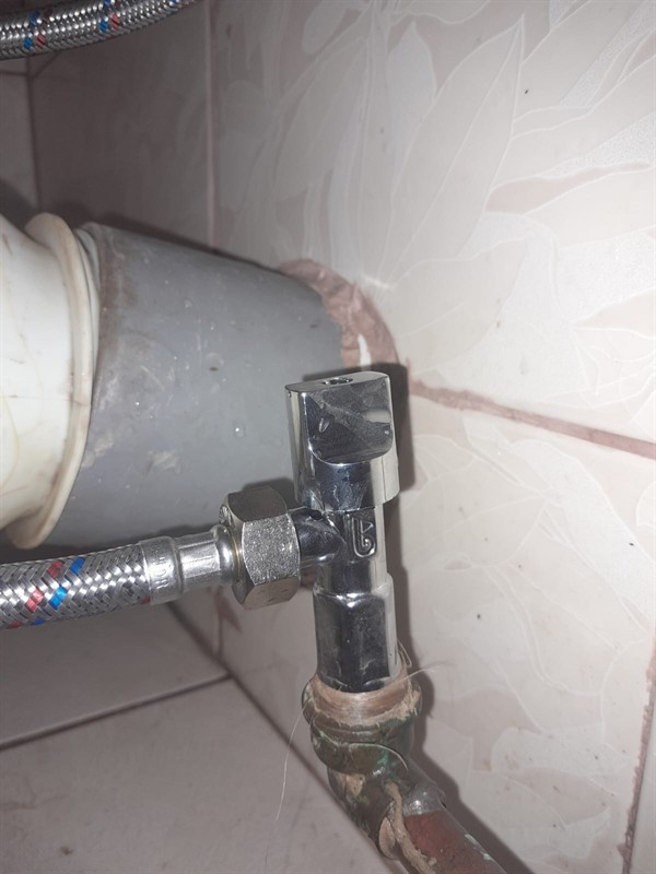 Close view of leaking toilet control valve