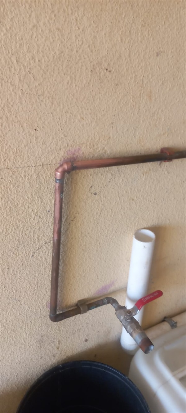 Spraying burst outside pipe with soaked ground in Fariaville