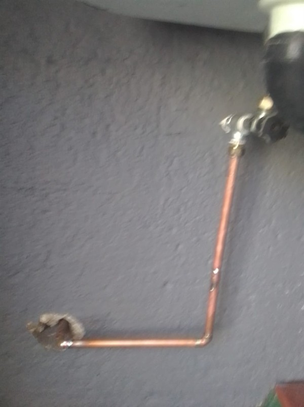 Running water across ground from burst outside pipe in Monument