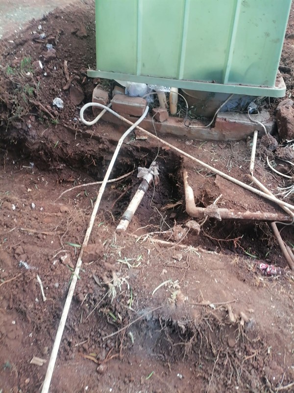 Wet patches appearing from burst underground pipe in The Gardens