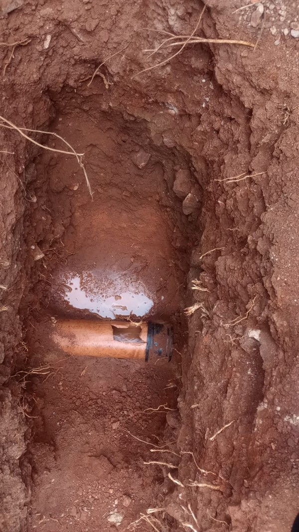 Water escaping from underground burst pipe causing damp areas in Theta