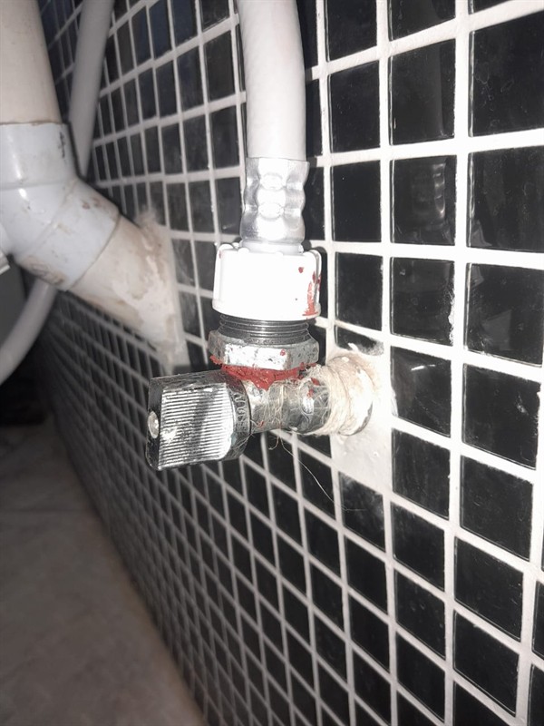Close view of faulty basin angle valve with drip marks in Chantelle