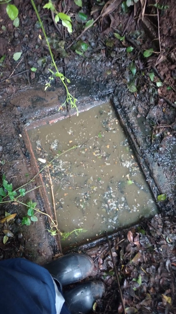 Heavy blockage visible inside drain pipe