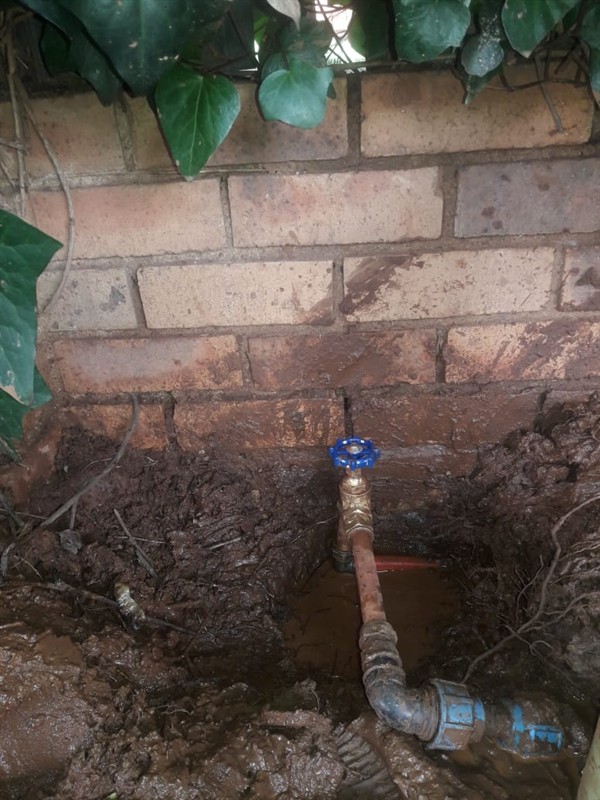 Water escaping from underground burst pipe causing damp areas in Putcoton