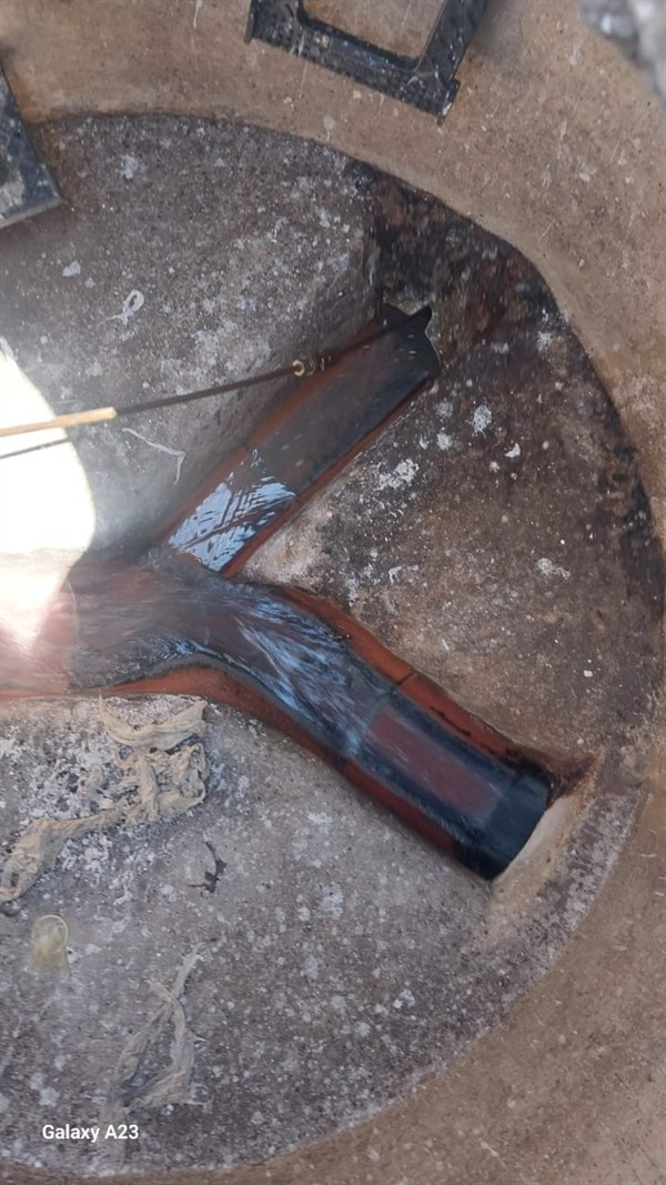 Blocked drain trap with debris visible