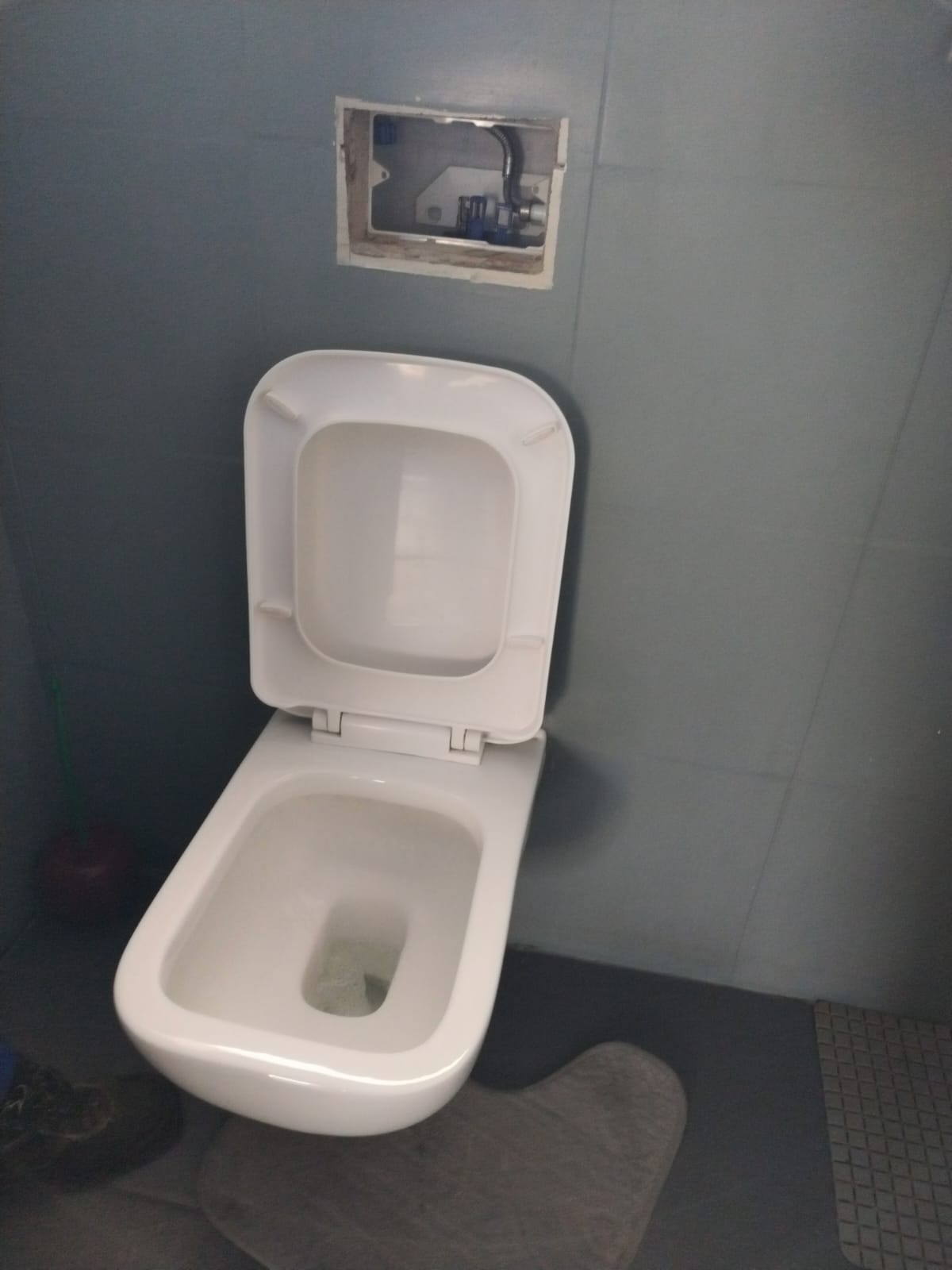 Geberit wall-mounted toilet in Randburg with access panel open, showing concealed cistern flushing mechanism repaired to restore proper flushing performance and eliminate faulty operation.