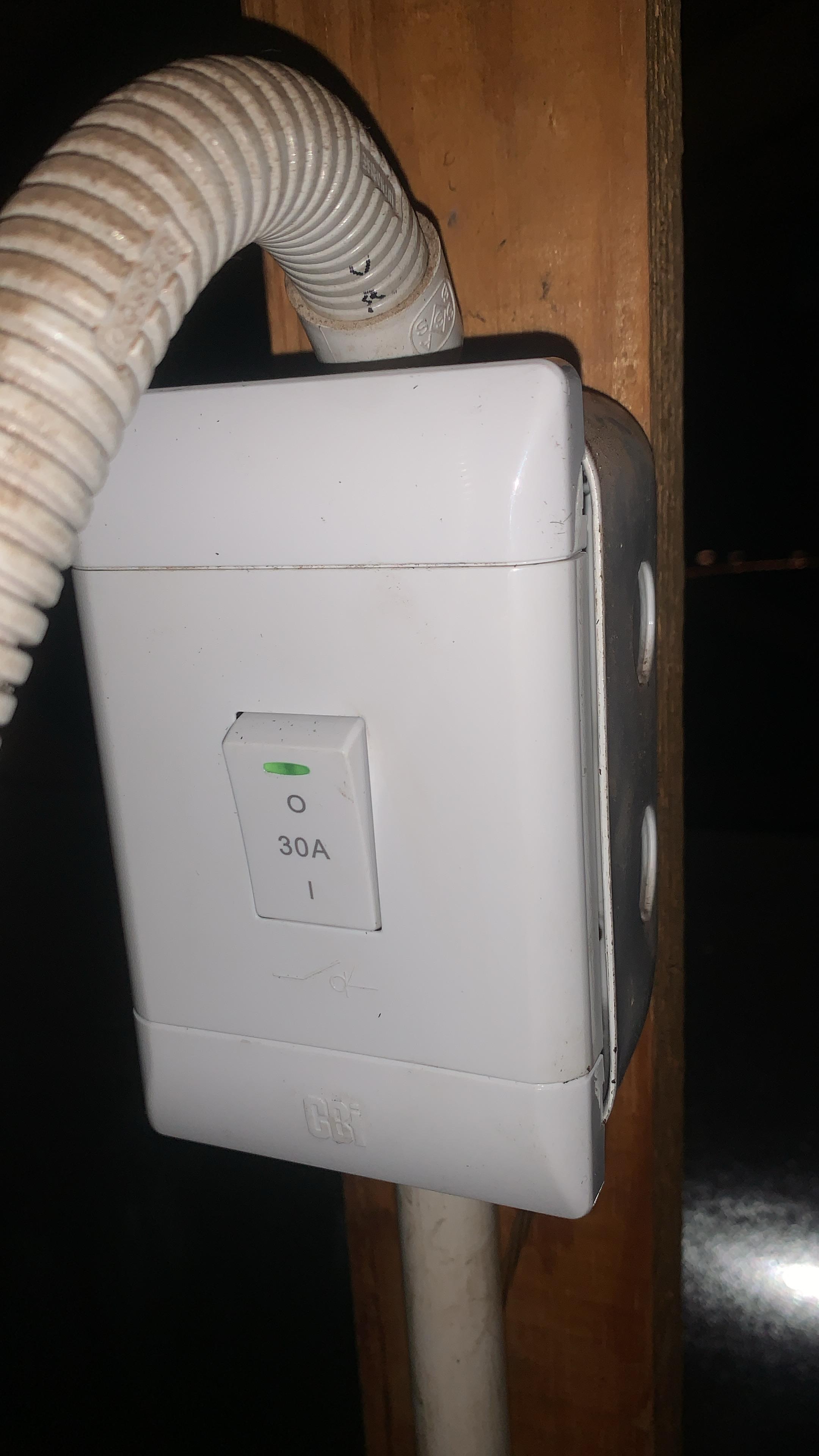 Newly installed 30A geyser isolator switch mounted on wooden beam in roof space in Pomona, showing electrical conduit and safe power isolation for geyser system.