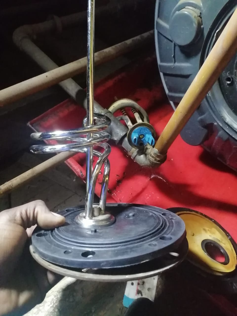 Faulty geyser element and thermostat removed during repair in Pomona, showing heating element assembly and open hot water cylinder during plumbing maintenance and replacement.