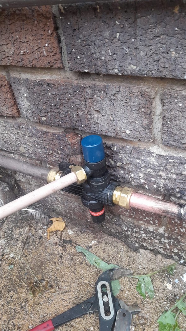 Technician repairing open geyser element and thermostat in Perdekop with exposed wiring and heating components