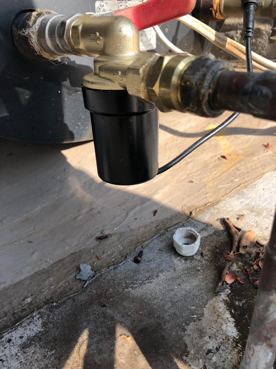Solar geyser circulation pump installed on hot water line with brass fittings and electrical connection, showing replaced circulation pump during repair to restore proper solar water heating and system circulation in Wadeville.