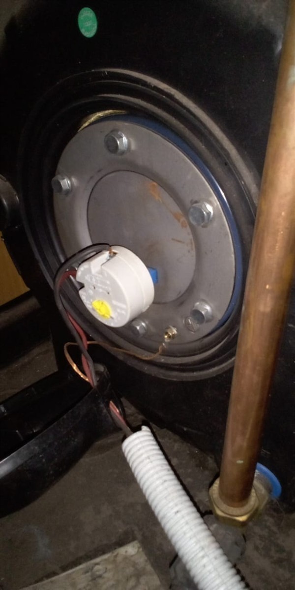 Open hot water geyser during thermostat and element repair in Kozeni with internal components visible