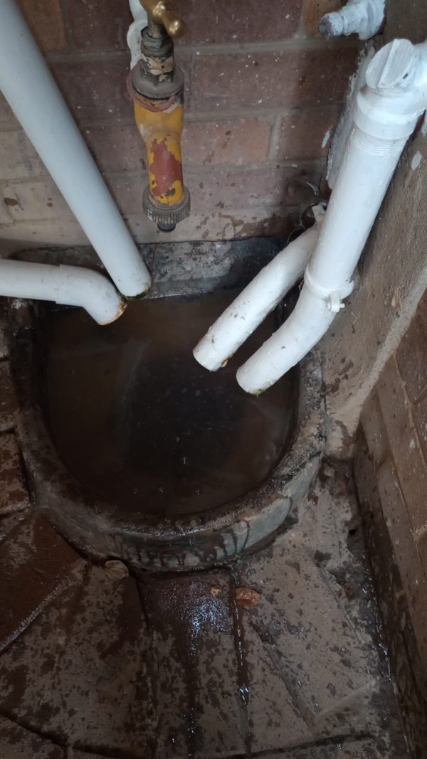 Drain cleaning job in progress with tools in use