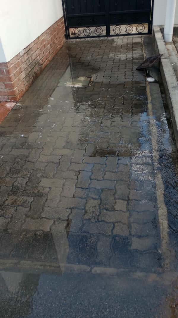 Drain pipe showing clear signs of blockage and poor drainage