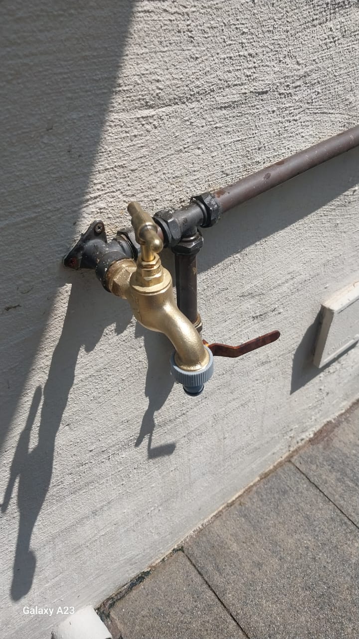 Newly installed brass garden tap in Kempton Park mounted on exterior wall with isolation valve and piping during outdoor tap replacement and plumbing repair.